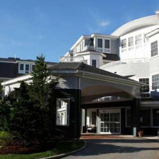 A large hotel building with distinct architecture, set against a clear blue sky.