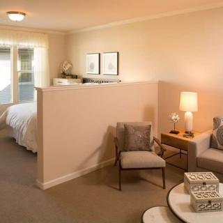 A cozy open-plan living area with a separate bedroom section.