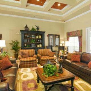 A cozy living room with elegant furniture and warm decor.