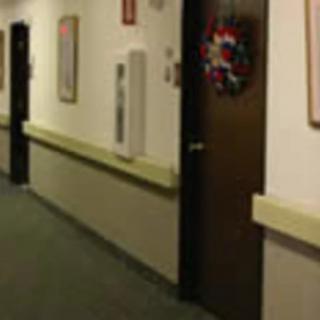 A hallway with a decorated door, possibly in an office or residential building.