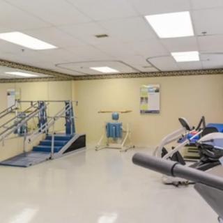A spacious indoor gym with various fitness equipment and exercise machines.