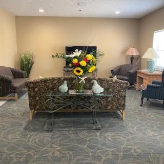 A cozy living room with comfortable seating and decorative elements.