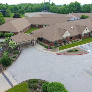 An aerial view of a well-maintained residential community surrounded by lush greenery.