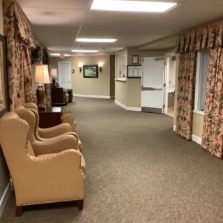 A well-lit indoor hallway with seating area and decorative elements.