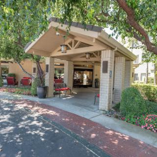 Entrance to a welcoming building surrounded by lush greenery.