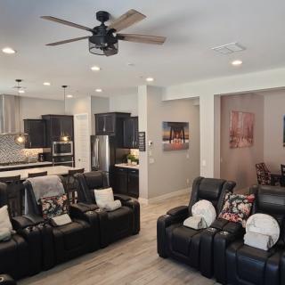 Open-concept living space with a modern kitchen and home theater seating.