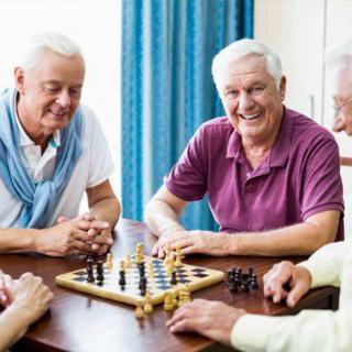 A group of seniors enjoying a game of chess together.