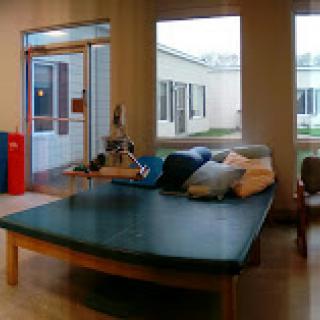A cozy lobby area with a large sofa and natural light coming through the windows.