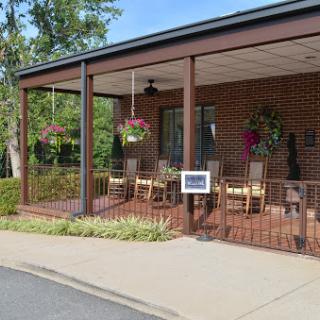 A cozy outdoor seating area with hanging flowers, perfect for enjoying a meal in the fresh air.