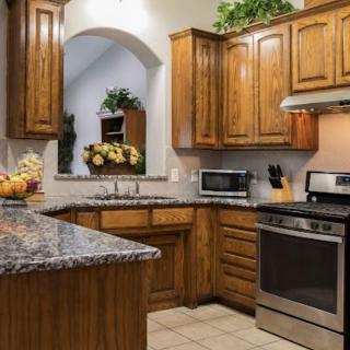 A cozy kitchen with wooden cabinets and modern appliances.