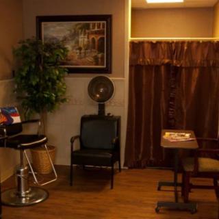 A cozy salon interior with a waiting area and hair dryer.