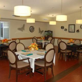 A cozy dining area with neatly arranged tables and elegant lighting.