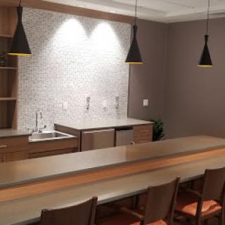 A sleek and modern kitchen bar area featuring stylish lighting and contemporary design elements.