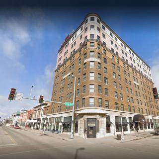 A historic multi-story corner building in an urban setting.