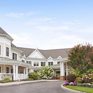 Elegant residential building with landscaped surroundings and a welcoming entrance.