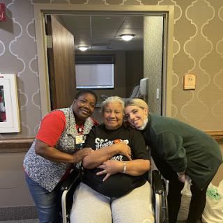 Caregivers sharing a joyful moment with a resident.