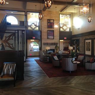 A spacious and elegantly designed lobby featuring comfortable seating areas and stylish lighting fixtures.