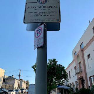 A street sign indicating parking regulations in an urban area.