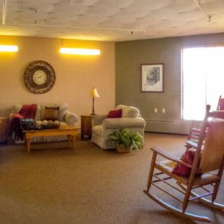 A cozy living room featuring comfortable seating and a rocking chair.
