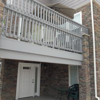 Two-story house with a brick exterior and a balcony above the porch.