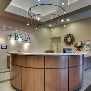 A modern office reception area with a curved desk and stylish decor.