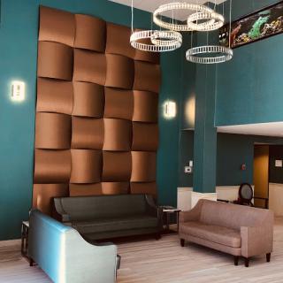 A stylish and modern lobby featuring unique wall design and contemporary furniture.
