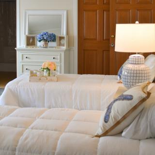 A cozy and elegantly decorated bedroom with soft lighting and a neatly arranged bed.