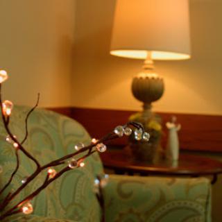 A cozy corner featuring decorative lights and a stylish lamp.