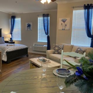 A cozy, modern studio apartment with stylish blue accents and comfortable furnishings.