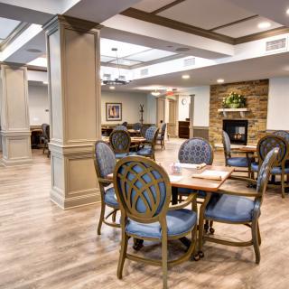 A well-appointed dining area with polished wood flooring and elegant furniture.