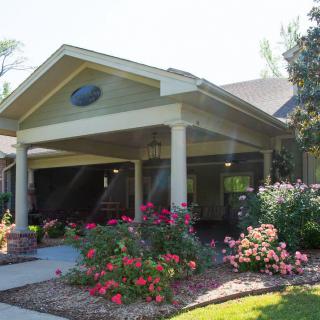A charming house with a beautifully landscaped garden and vibrant flowers.