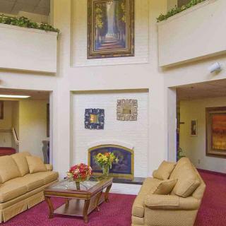 A cozy lobby area with sofas and decorative artwork.