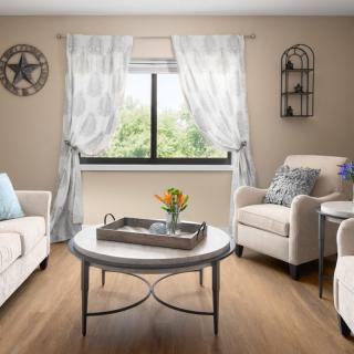 A cozy living room with comfortable seating and inviting decor.