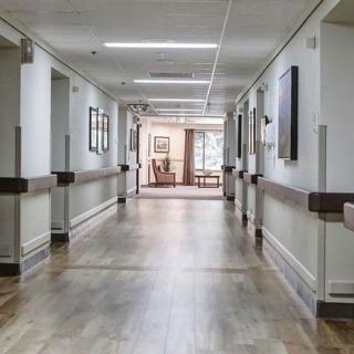 An empty hospital corridor with clean, well-lit surroundings.