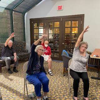 Seniors participating in a group exercise class, focusing on movement and wellness.