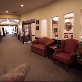 A cozy lobby area with chairs and warm lighting.