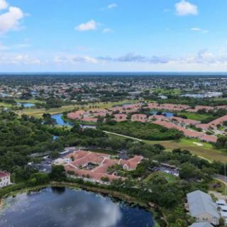 An aerial view of a suburban residential area with lakes and greenery.