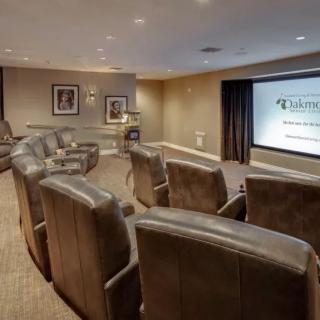 A luxurious home theater setup with comfortable seating and a large screen.