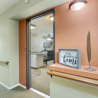 A modern hallway entrance with a decorative sign that reads 'the perfect home'.