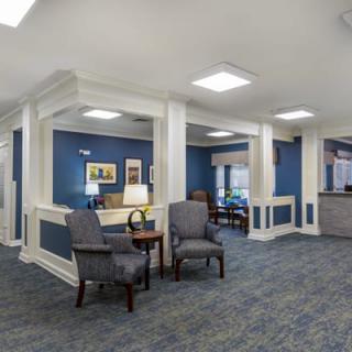 A modern, spacious lobby area with comfortable seating and blue accents.