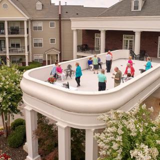 A group of elderly individuals enjoying a fitness session on a rooftop patio.