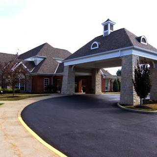 A well-designed residential building with a welcoming entrance and neatly paved driveway.