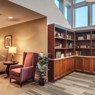 A cozy library corner with a comfortable reading chair and well-organized bookshelves.
