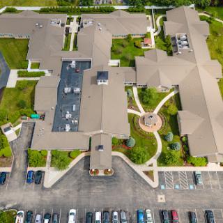 An aerial view of a spacious community center with landscaped paths and parking facilities.
