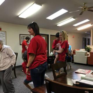 Volunteers interacting with residents at a nursing home.