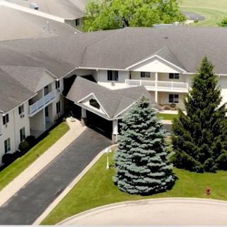 An aerial view of a residential building surrounded by greenery.