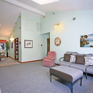A cozy living room with modern furniture and decorative elements.
