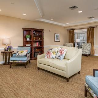 A cozy living room with comfortable seating and a bookshelf for relaxation.