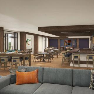 A modern dining space with a bar area featuring wood accents and comfortable seating.