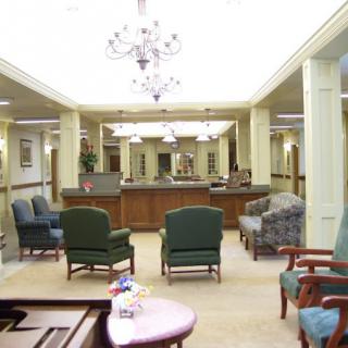 A well-lit lobby area with comfortable seating and a reception desk.